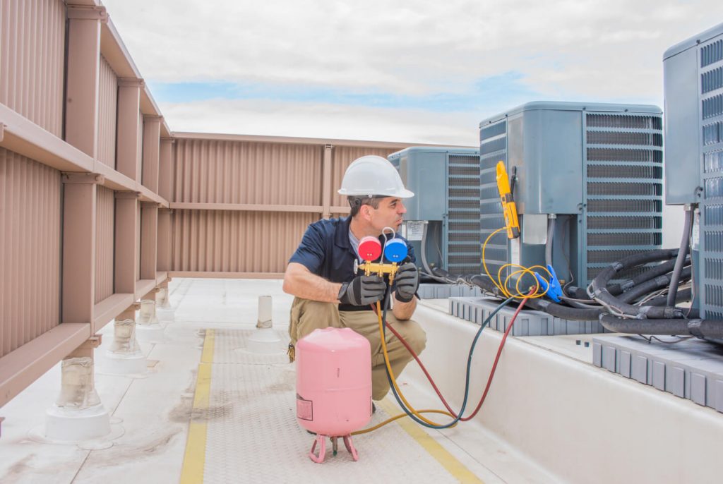 commercial HVAC technician on the roof